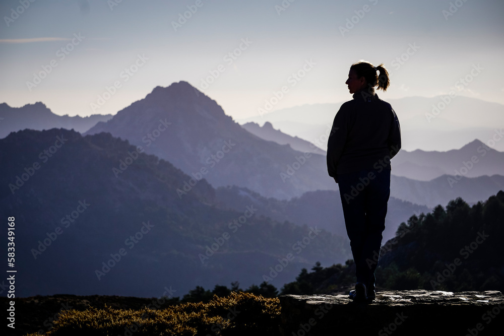 Young Caucasian woman dressed in jeans and sweatshirt enjoying the views of the Alpujarra valleys of Granada