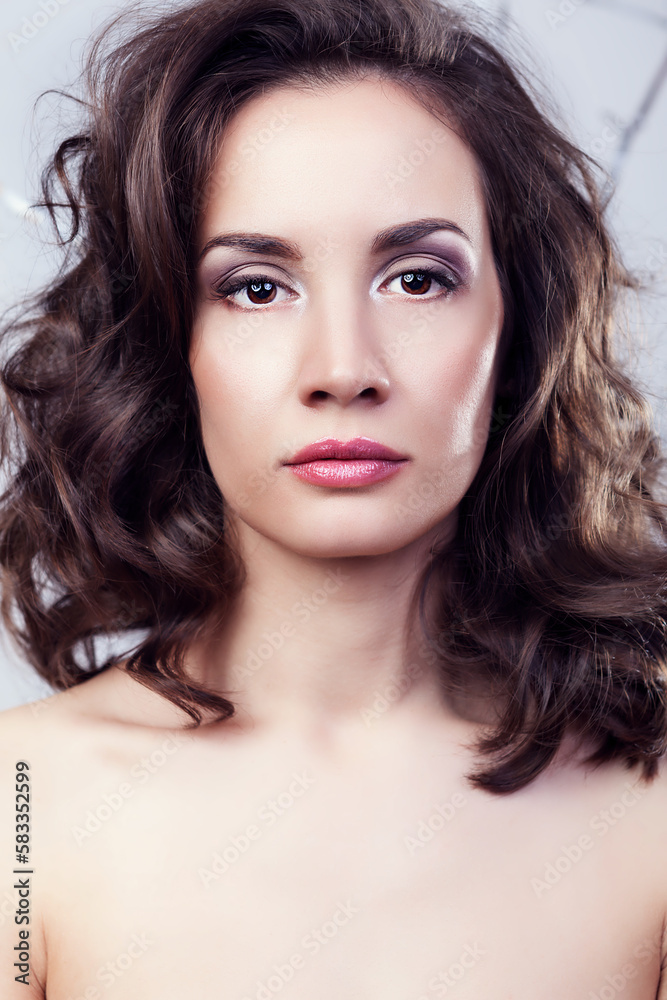 Fototapeta premium Portrait of gorgeous woman on grey background in studio photo. Professional make up and hairstyle. Elegance and romance
