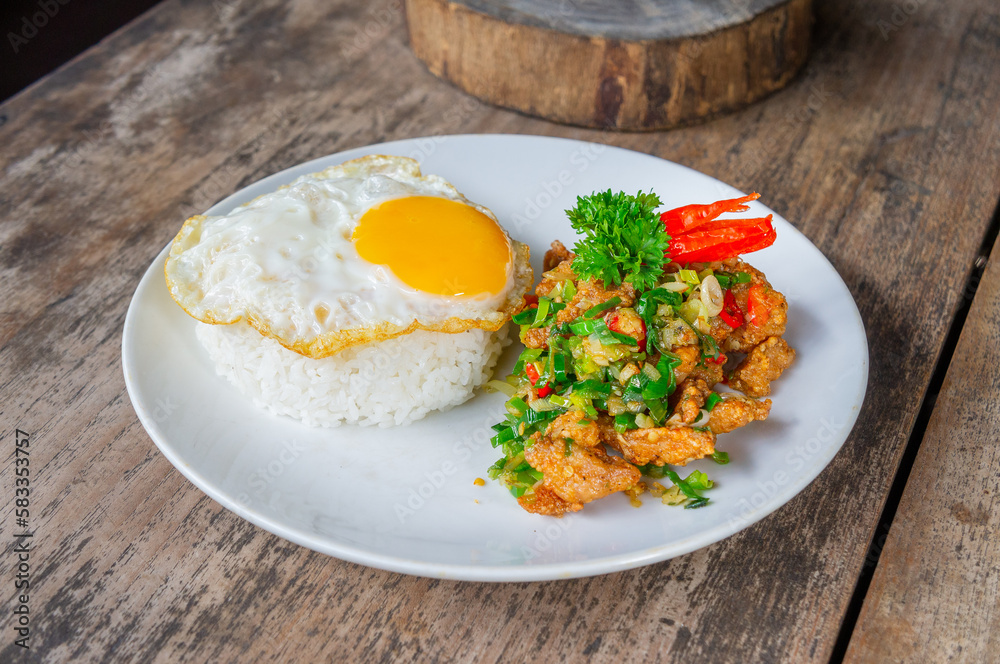 Delicious Salt Pepper Chicken or Ayam Cabe Garam with Fried Egg on Steam Rice Delicious Salt Pepper Chicken or Ayam Cabe Garam with Fried Egg on Steam Rice