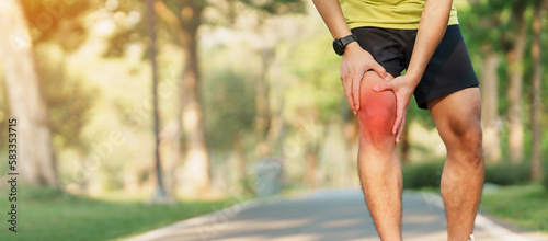 Young adult male with muscle pain during running. runner have knee ache due to Runners Knee or Patellofemoral Pain Syndrome, osteoarthritis and Patellar Tendinitis. Sports injuries and medical concept photo