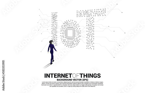 Silhouette of businessman walking with CPU processor on center of IoT wording from Circuit dot and line graphic style. Concept for internet of Things Technology.