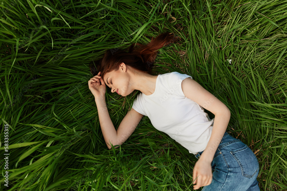woman lies in tall grass falling asleep in nature woman lies in tall grass falling asleep in nature