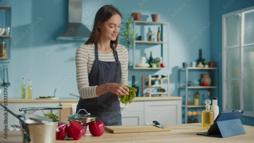 Smiling Woman Preparing Vegetable Meal and Watch Recipes on Tablets in Internet.Vegetarian Woman Cooking Healthy Food Salad Using Cookbook. Lifestyle, On-line Recipes, Food Delivery Services Concept. Smiling Woman Preparing Vegetable Meal and Watch Recipes on Tablets in Internet.Vegetarian Woman Cooking Healthy Food Salad Using Cookbook. Lifestyle, On-line Recipes, Food Delivery Services Concept.