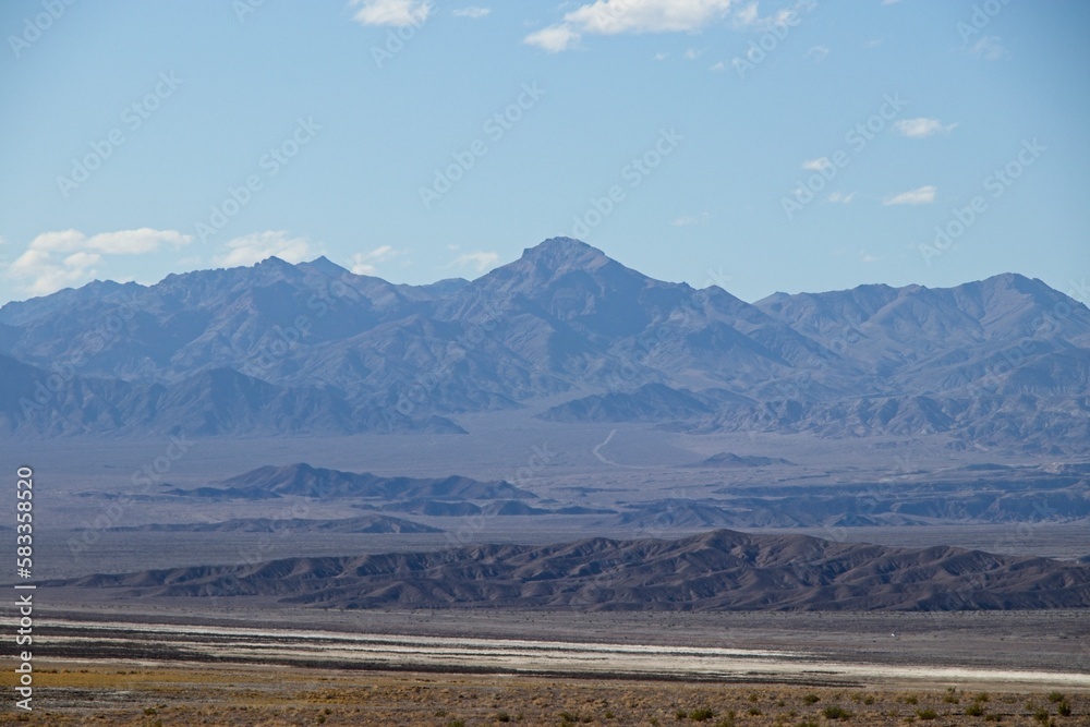 Heading out of Death Valley to the north, mountains rise above the California-Nevada border, part of the seemingly endless series of parallel mountain ranges making up the  Basin and Range region.