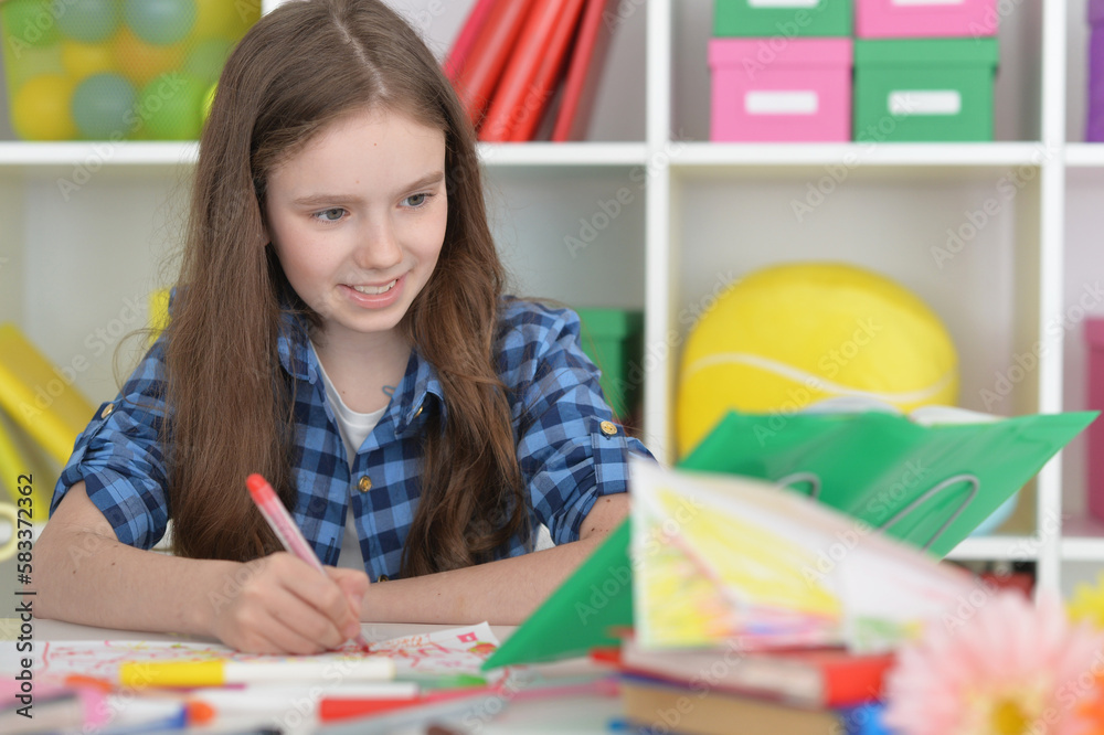 cute girl doing homework sitting at the table cute girl doing homework sitting at the table