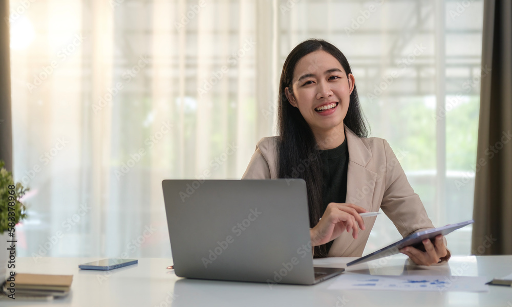 Portrait of young businesswoman in stylish suit holding clipboard and smiling at camera. Portrait of young businesswoman in stylish suit holding clipboard and smiling at camera.