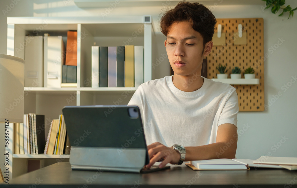 Smiling man student doing homework, working on research project online watching remote education online class o movie series on laptop. Smiling man student doing homework, working on research project online watching remote education online class o movie series on laptop.