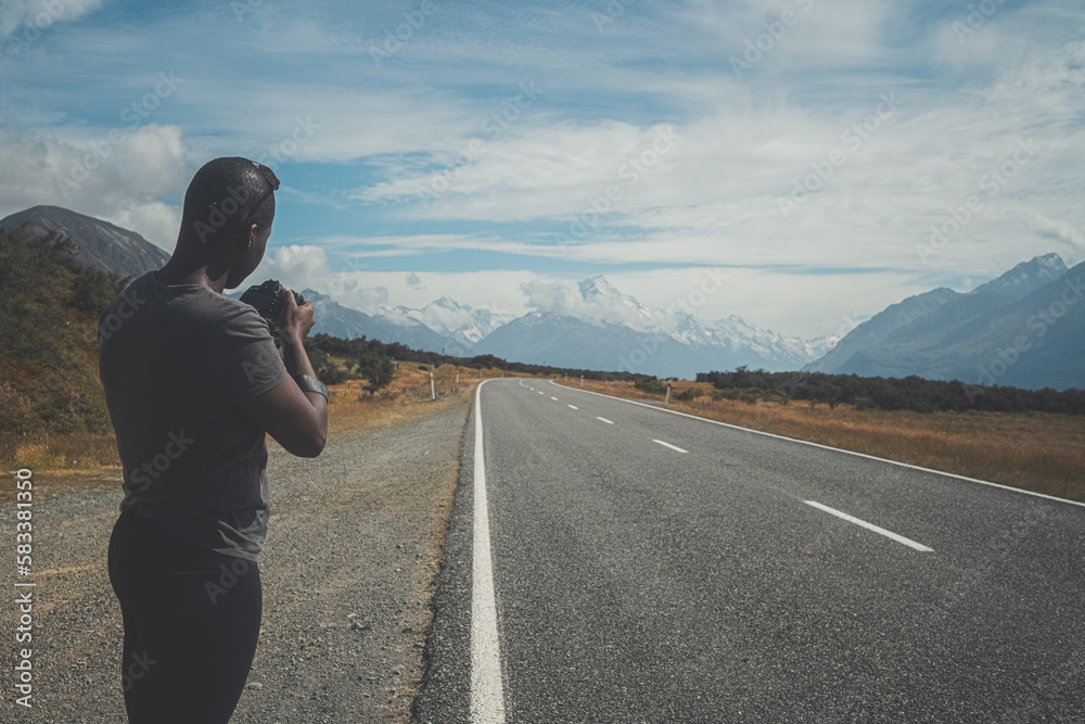 Photographer capturing road and mountains