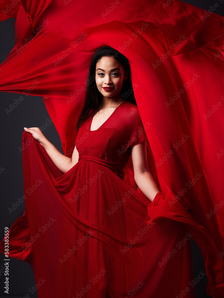 Woman, art and fashion, red fabric on dark background with beauty and aesthetic movement. Flowing silk motion, fantasy and artistic portrait of model with smile in designer dress and veil in studio Woman, art and fashion, red fabric on dark background with beauty and aesthetic movement. Flowing silk motion, fantasy and artistic portrait of model with smile in designer dress and veil in studio