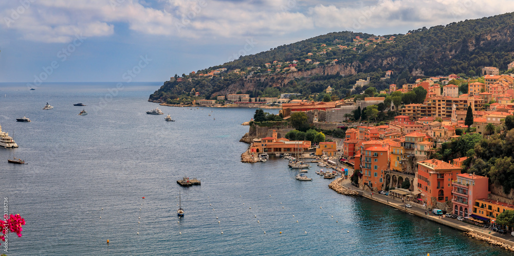 Villefranche sur Mer medieval town in South of France with bougainvillea blossom