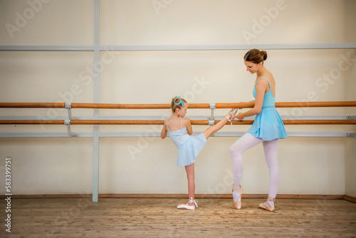 Little ballerina. Choreographer and student. Ballerinas. Girl and ballet teacher. The girl is learning to dance. Ballerinas on pointe. Ballerinas in tutus. Ballet and dance training. Dancers. Pointe