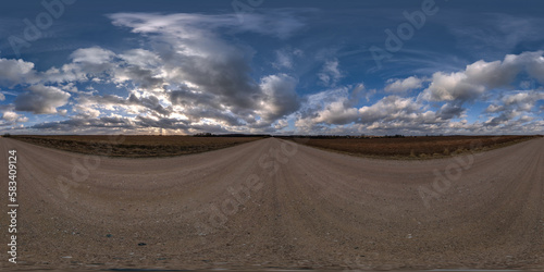 evening 360 hdri panorama on gravel road with clouds on blue sky before sunset in equirectangular spherical seamless projection, use as sky replacement in drone panoramas, game development as sky dome