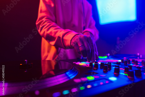 Obraz na plátně Hands of a DJ creating and regulating music on dj console mixer at club concert