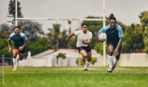 Rugby, running or sports men in game playing a training game for cardio exercise or workout outdoors. Fitness speed, black man or fast African athlete player with ball exercising on field in stadium © Delcio/peopleimages.com