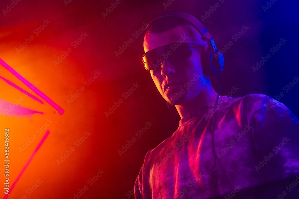 Club DJ playing music at party wearing sunglasses Club DJ playing music at party wearing sunglasses