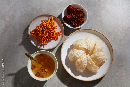 Flat lay of bird’s nest soup, jujube inside a bowl, a dish of edible bird’s nest and cordyceps. Bird's nest and herbs are well-known in Korea and China as a traditional medicine photo