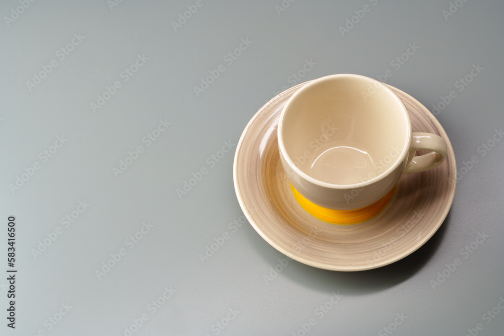 Top view of ceramic cup with saucer on gray background Top view of ceramic cup with saucer on gray background