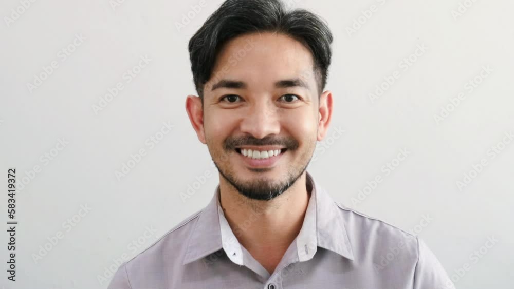 Handsome Asian businessman in suit looking at camera and slowly smiling. slow motion 4k. Handsome Asian businessman in suit looking at camera and slowly smiling. slow motion 4k.