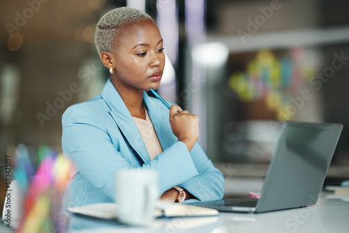 Laptop, idea and a serious business black woman in her office on a review, proposal or project. Work, focus and thinking with a female employee reading an email or doing research while working