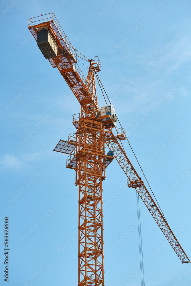 Construction crane with blue sky in the background Construction crane with blue sky in the background