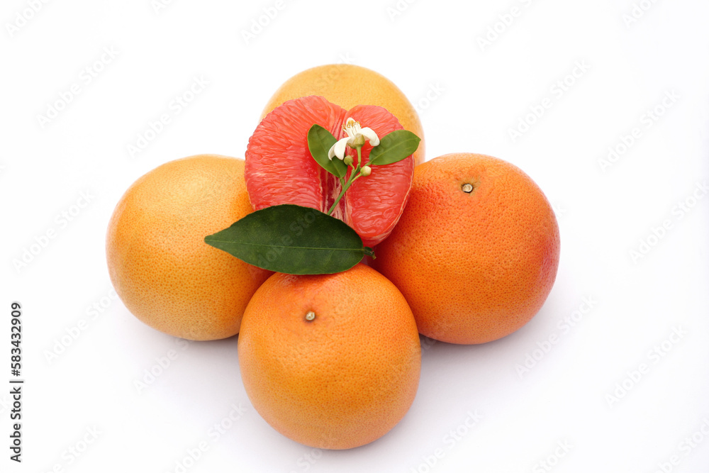 Fresh grapefruits and green leaves on white background Fresh grapefruits and green leaves on white background
