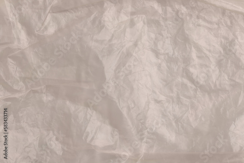 Crumpled yellow plastic bag as background, top view