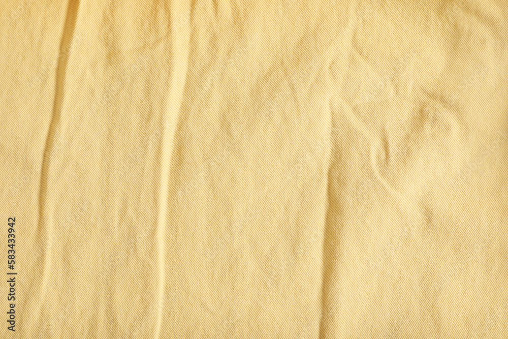 Crumpled pale yellow fabric as background, top view Crumpled pale yellow fabric as background, top view