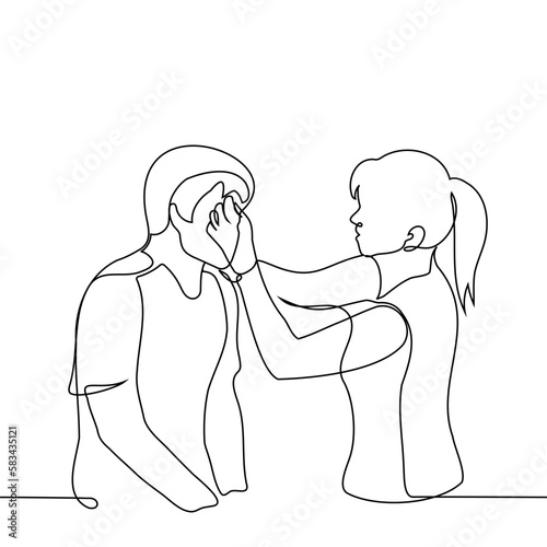woman touching forehead of man sitting in front of her - one line drawing vector. concept a doctor or nurse treats a wound on the head, a female makeup artist applies makeup