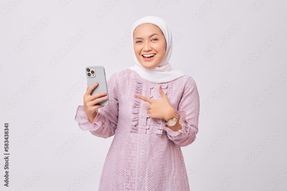 Φωτογραφία Cheerful beautiful young Asian Muslim woman wearing hijab and purple dress point