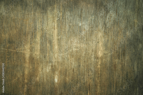 Photo of the texture of an old wooden background. The wall is made of ancient wood. Cracks on the countertop.