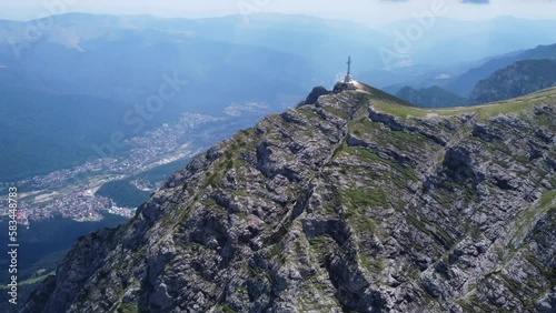 Discover the breathtaking views of Bucegi Mountains from above with this stunning drone footage of the Crucea Caraiman photo