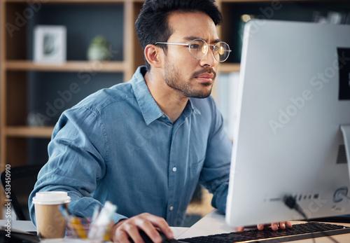 Serious, business man and confused on computer, internet research and website. Focused male employee, desktop and problem solving solution, planning and review strategy, project and reading email