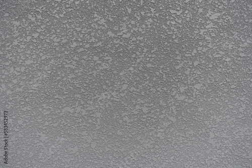 Surface of gray semi-smooth wall with stucco lace finish