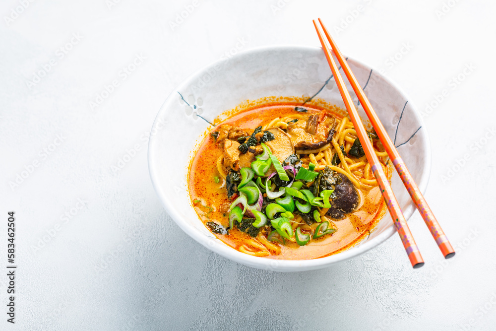 Thai red curry noodle soup with shiitake,  coconut milk and onions