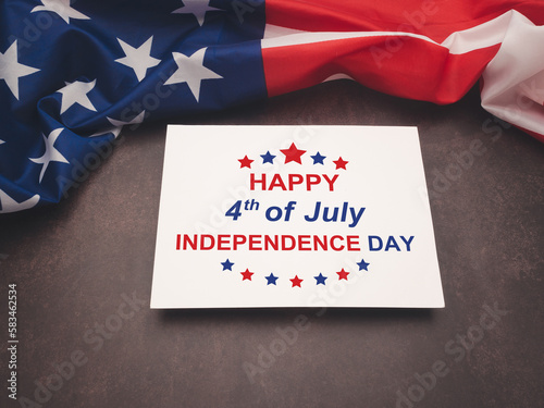American flag and the text of Happy 4th of July Independence day on a white paper over the vintage background
