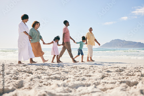 Holding hands, vacation and family on beach, walking and break to relax, happiness and ocean water waves. Grandparents, father and mother with grandkids, seaside holiday and quality time together