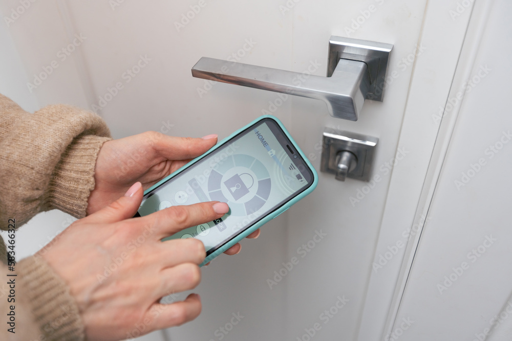 Hotel door security Unlocking by application on mobile phone. Digital door lock, key less system of access door. Close up Hotel door security Unlocking by application on mobile phone. Digital door lock, key less system of access door. Close up