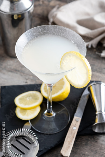Lemon drop martini cocktail on wooden table. Copy space