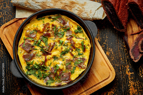 Tableau sur toile Menemen with eggs, Sujuk, green peppers, and spices served with bread in pan