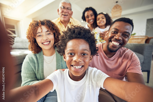 Generations, smile and selfie with black family in living room for social media, bonding and relax. Happiness, picture and proud with parents and children at home for memory, support and weekend © Charlize D/peopleimages.com