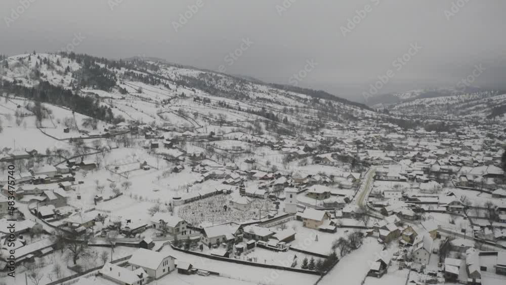 Panoramic view of a snow covered town with mountains in the background. Panoramic view of a snow covered town with mountains in the background.