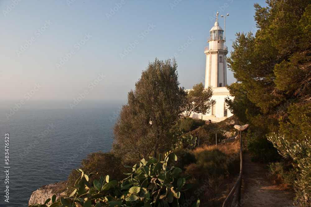 mediterranean lighthouse in front of blue sky