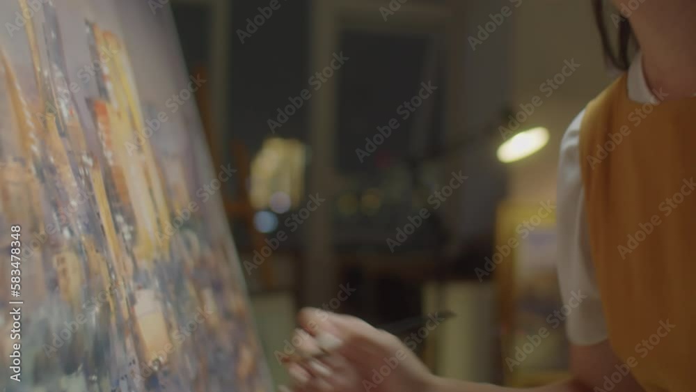 Vidéo Stock Close up tilt down shot of young Asian female painter ...
