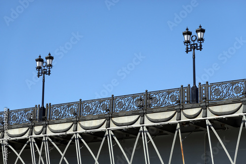 Part of Patriarchal Bridge in Moscow with vintage lanterns and openwork forged parapet photo