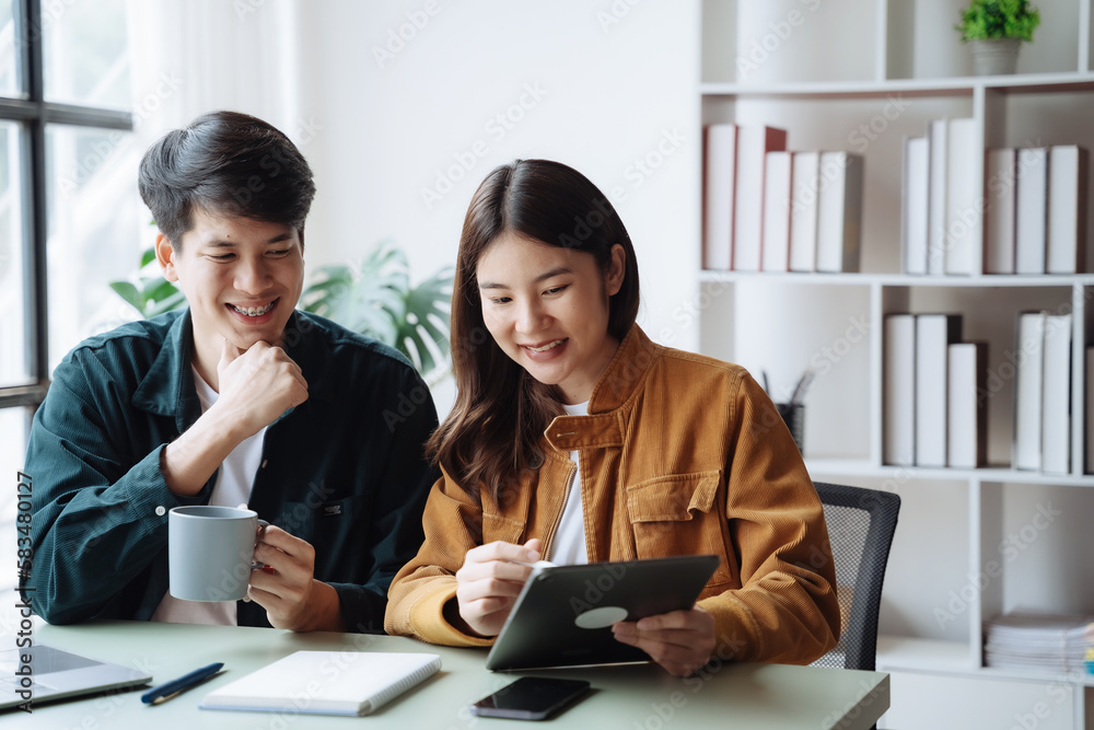Happy Asian couple lover using laptop together at home in the morning. Happy Asian couple lover using laptop together at home in the morning.
