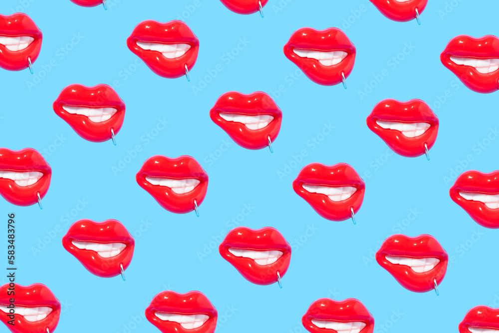 Seamless pattern made of sensual red lips with piercing ring on blue background. Seamless pattern made of sensual red lips with piercing ring on blue background.