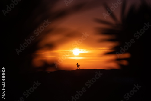 Silhouette of a couple on a tropical beach at sunset