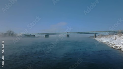 Wallpaper Mural Flying Quickly Over Fog Covered Missouri River Along Snow Covered Shoreline on Winter Day Towards Bridge In Bismarck, North Dakota Torontodigital.ca
