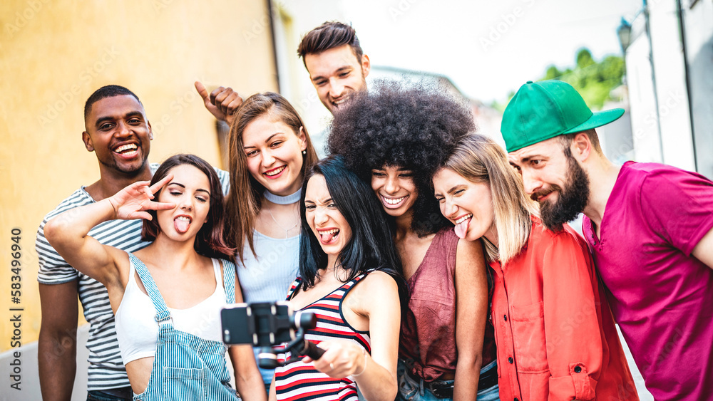 Multi racial friends taking video selfie with mobile phone on stabilize gimbal - Diverse people having fun on new tech trend - Life style concept with millenial sharing content on social media channel Multi racial friends taking video selfie with mobile phone on stabilize gimbal - Diverse people having fun on new tech trend - Life style concept with millenial sharing content on social media channel