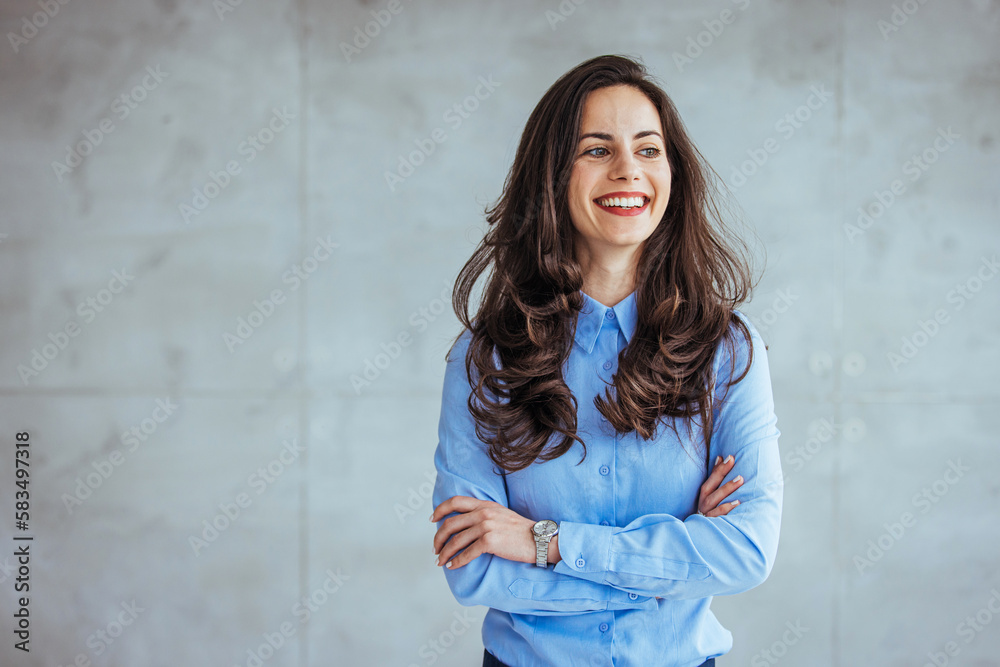 One Happy Pretty Business Woman Standing in Hall and looking at camera with smile. Studio headshot on white background. Spanish model. Portrait of a confident young businesswoman working